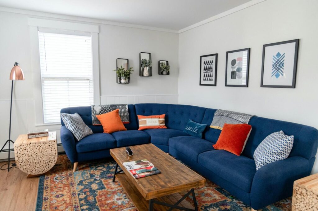 Blue corner sofa with throw back to front