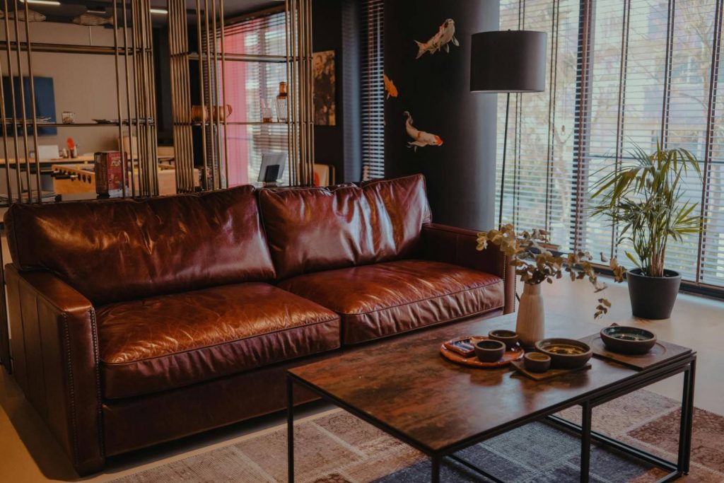 wooden coffee table with brown leather couch