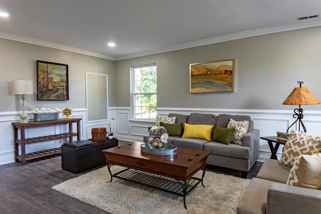 Wooden coffee table with a grey couch